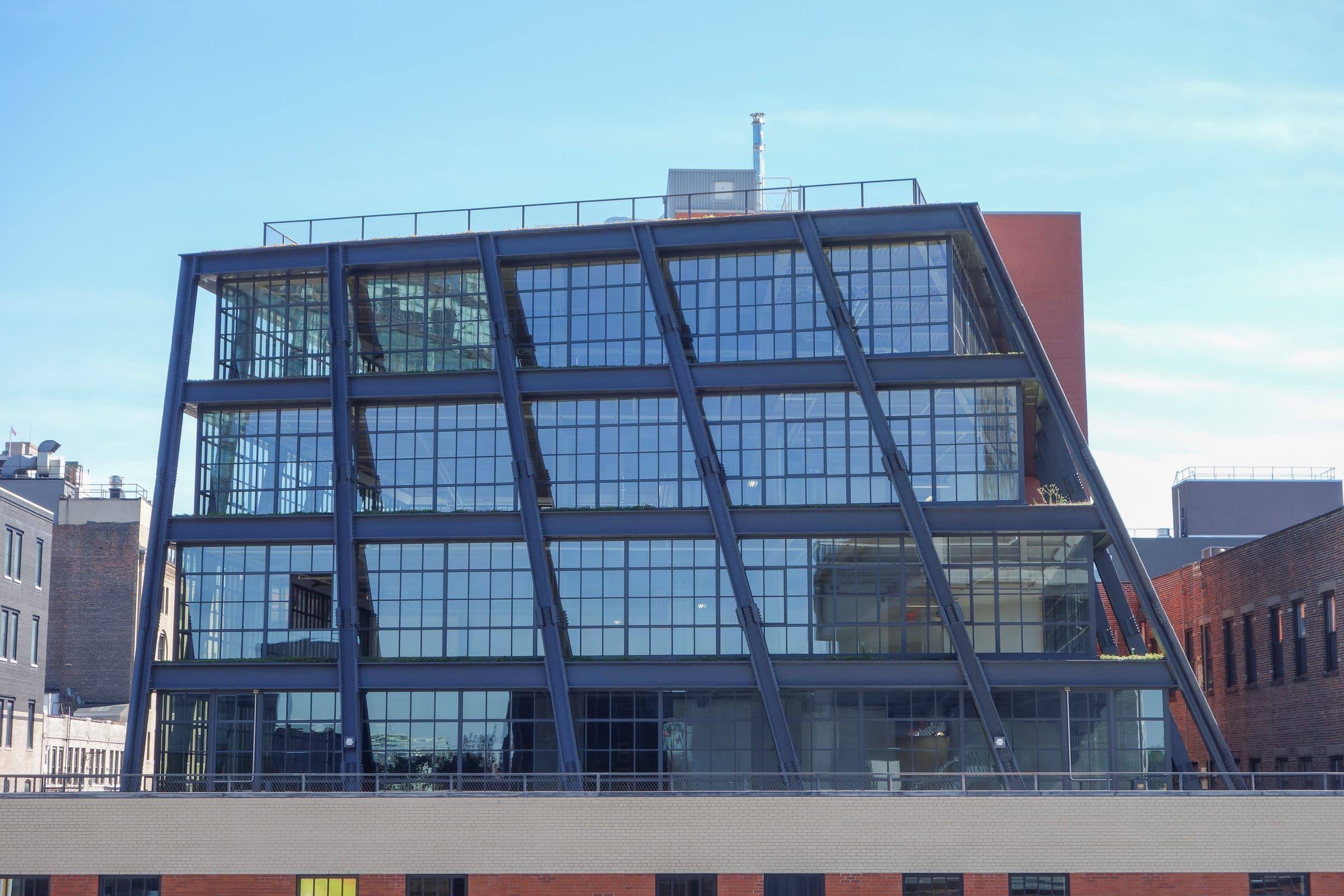 Striking inclined glass façade of a modern office building